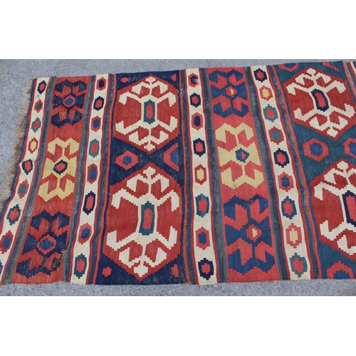 14 - Kelim runner with all-over hooked medallion design in shades of red, blue, cream and yellow, 340cms ... 