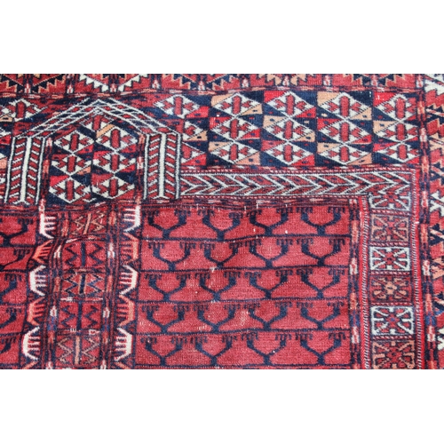 15 - Turkoman prayer rug with a quartered panel design and multiple borders with wine ground, 135cms x 12... 