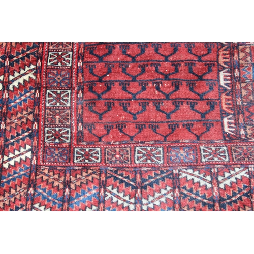 15 - Turkoman prayer rug with a quartered panel design and multiple borders with wine ground, 135cms x 12... 