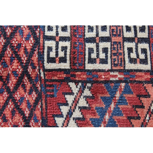 15 - Turkoman prayer rug with a quartered panel design and multiple borders with wine ground, 135cms x 12... 