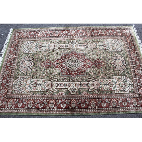 16 - Turkish cotton silk style rug with medallion and all-over design on a pale green ground with rose pi... 