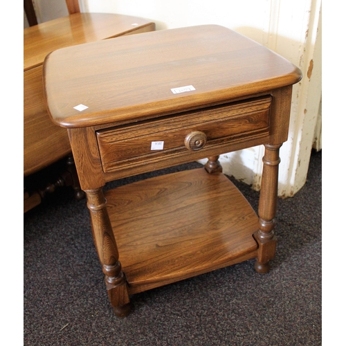 1859 - Ercol oval drop-leaf coffee table on turned supports, 107cms wide together with a similar lamp table... 