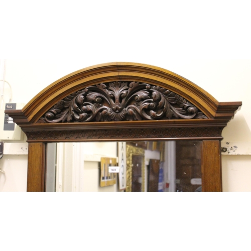 1902 - Late 19th / early 20th Century walnut wall mirror with a carved broken arch surmount, 166cms x 85cms