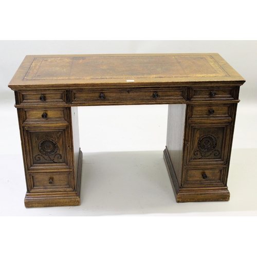 1913 - Howard & Sons, small oak pedestal desk with brown leather and gilt tooled inset top above an arrange... 