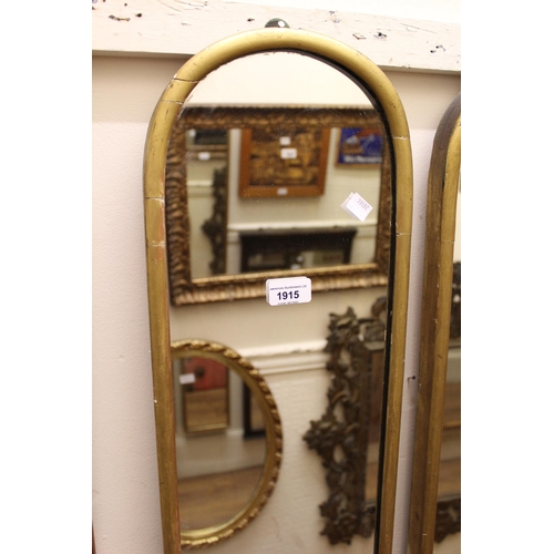 1915 - Pair of Victorian gilt framed dome top hall mirrors, 143cms high x 23cms wide