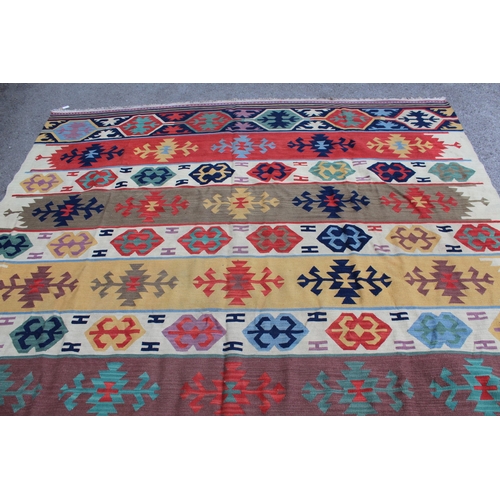 20 - Large modern Kelim carpet with an all-over polychrome hooked medallion design, 325cms x 240cms appro... 