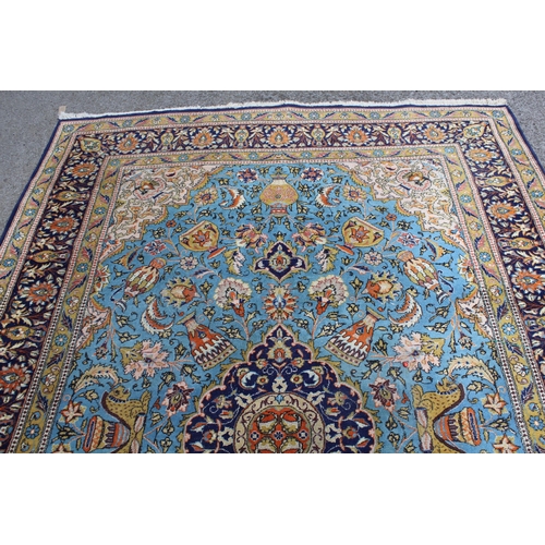 23 - Indo Persian carpet with a medallion and all-over stylised design on a sky blue ground with corner d... 