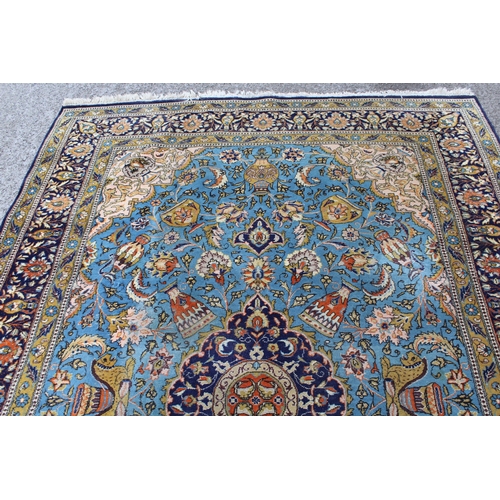 23 - Indo Persian carpet with a medallion and all-over stylised design on a sky blue ground with corner d... 