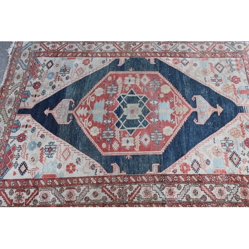 25 - Antique Kurdish rug with a lobed medallion design in shades of red, blue and beige (some wear)