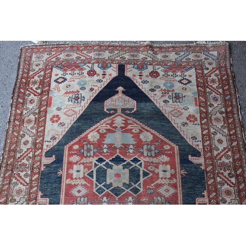 25 - Antique Kurdish rug with a lobed medallion design in shades of red, blue and beige (some wear)