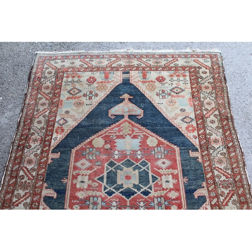 25 - Antique Kurdish rug with a lobed medallion design in shades of red, blue and beige (some wear)