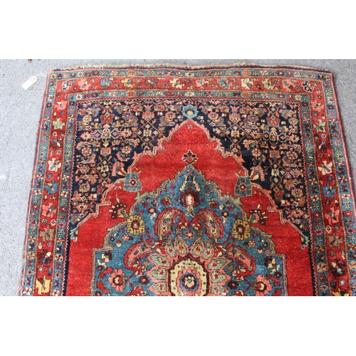 28 - Small antique Bidjar rug with a medallion and a plain design, with Herati corner designs and borders... 