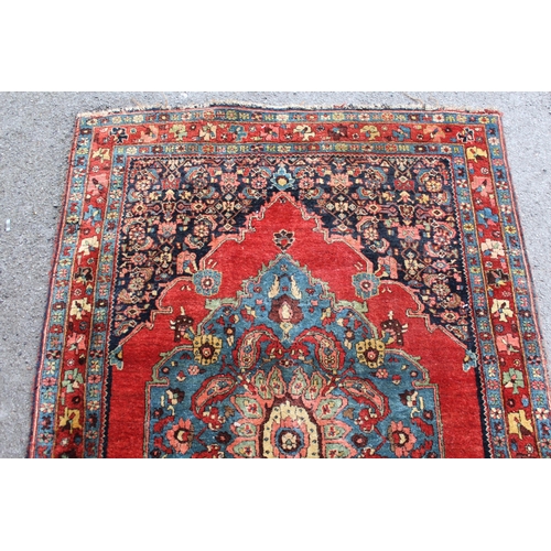 28 - Small antique Bidjar rug with a medallion and a plain design, with Herati corner designs and borders... 