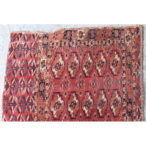 34 - Antique Tekke Juval with five rows of five gols on a wine ground with borders and skirt panel, (vari... 