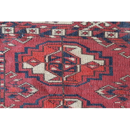 34 - Antique Tekke Juval with five rows of five gols on a wine ground with borders and skirt panel, (vari... 