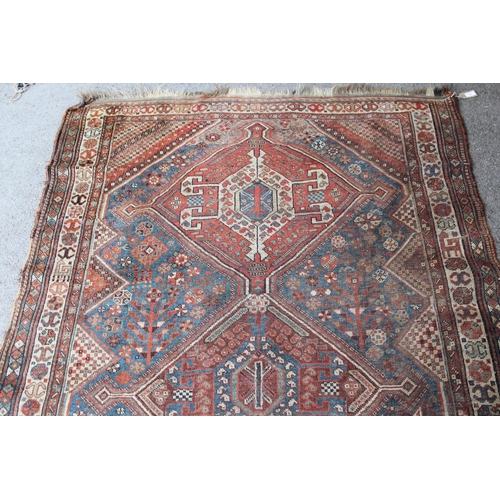 36 - Antique Qashqai rug with a triple medallion and all-over design with borders, 242cms x 155cms approx... 