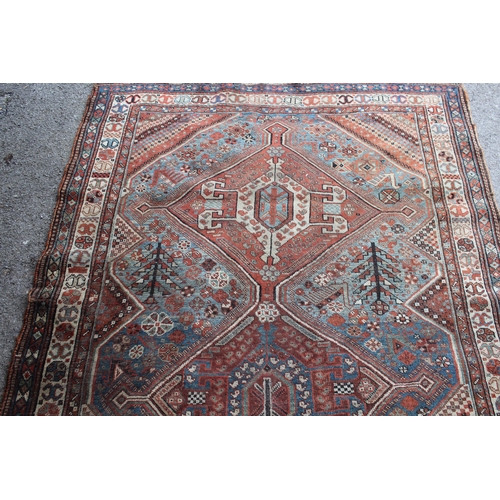 36 - Antique Qashqai rug with a triple medallion and all-over design with borders, 242cms x 155cms approx... 