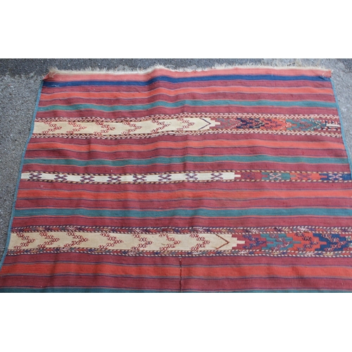 39 - Kelim rug with a polychrome banded design, 270cms x 133cms approximately (repairs and damages)