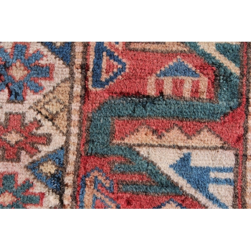 43 - 20th Century Kazak rug with a medallion and all-over stylised design on a red ground with multiple b... 