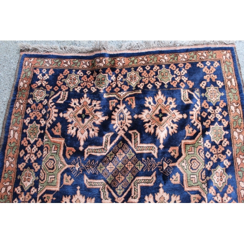 45 - Chobi rug with an all-over stylised design on a midnight blue ground with borders, 168cms x 119cms