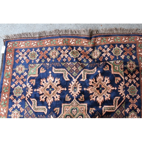 45 - Chobi rug with an all-over stylised design on a midnight blue ground with borders, 168cms x 119cms