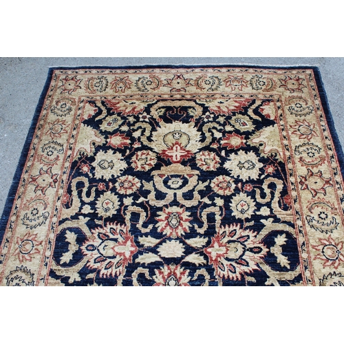 46 - Modern Afghan rug of Ziegler design with a palmette pattern on a dark blue ground, with beige and ro... 