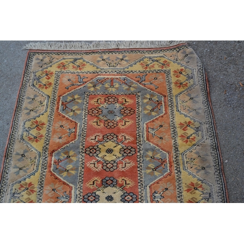 5 - Modern Turkish rug with a line of central medallions on rose pink ground with twin borders, 201cms x... 