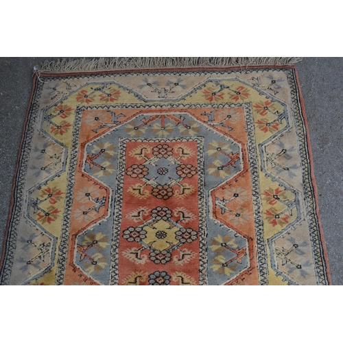 5 - Modern Turkish rug with a line of central medallions on rose pink ground with twin borders, 201cms x... 