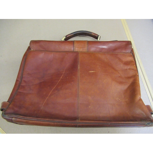 62 - Tan leather attaché case by Piquadro, together with another leather briefcase