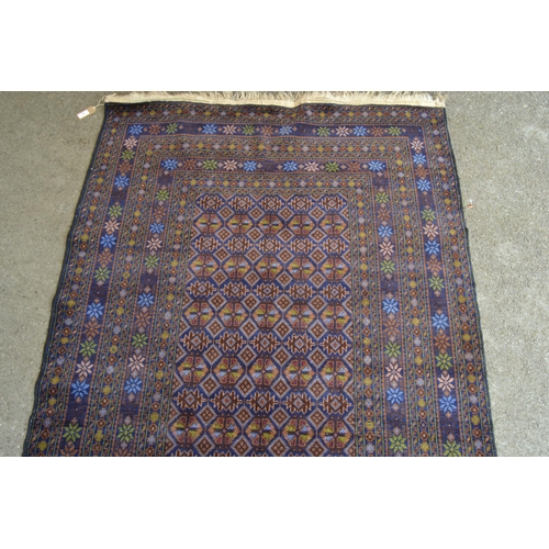 9 - Modern Belouch rug with an all-over stylised flower head design in rectangular centre panel, with mu... 