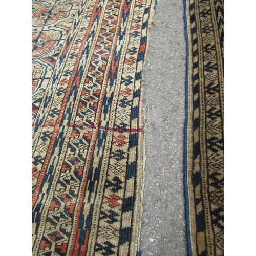 48 - Turkoman rug, the three rows of gols and multiple borders, on a faded red ground, together with anot... 