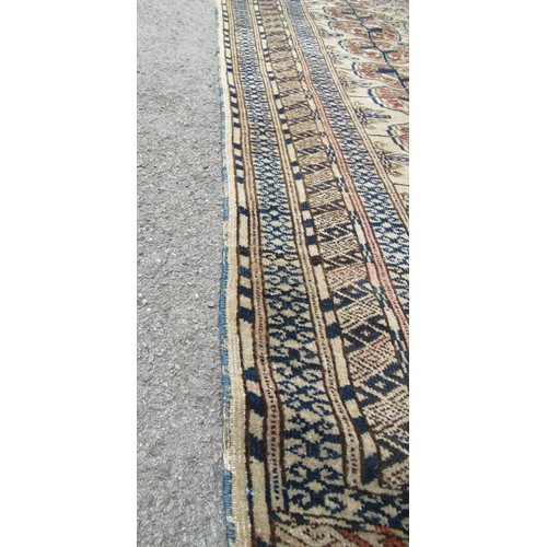 49 - Turkoman rug, the three rows of gols and multiple borders on a washed beige, red and blue ground, to... 