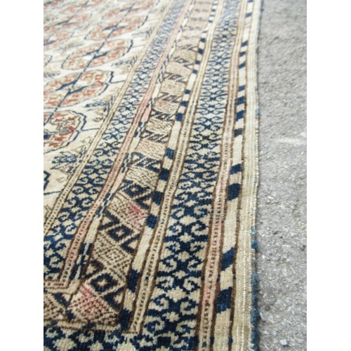 49 - Turkoman rug, the three rows of gols and multiple borders on a washed beige, red and blue ground, to... 