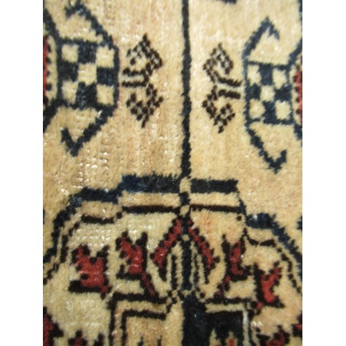 49 - Turkoman rug, the three rows of gols and multiple borders on a washed beige, red and blue ground, to... 