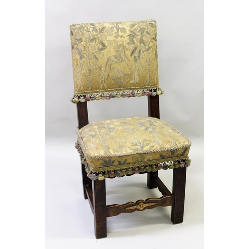 Set of eight 17th Century style walnut dining chairs with upholstered panel backs and seats, on square supports tied by shaped carved stretchers