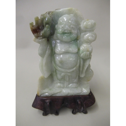 109 - Small 20th Century celadon jade figure of a standing Buddha, 9cm high with hardwood stand