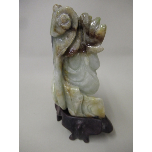 109 - Small 20th Century celadon jade figure of a standing Buddha, 9cm high with hardwood stand