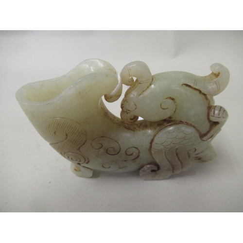 111 - Pale green jade libation cup in the form of a stylised bird, 7.5cm x 10.5cm approximately