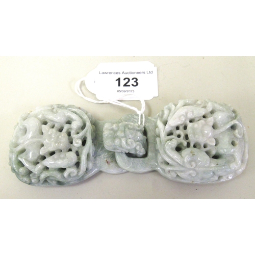 123 - 20th Century carved mottled pale green jade belt buckle in two parts, decorated in deep relief, 12.5... 