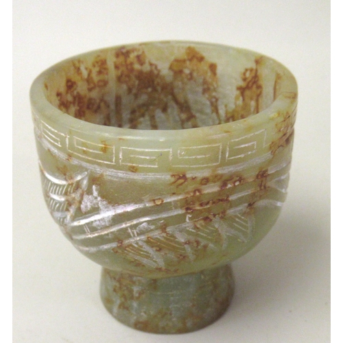 124 - 20th Century carved mottled green/rust jade stem cup, decorated in shallow relief, 5.5cm high