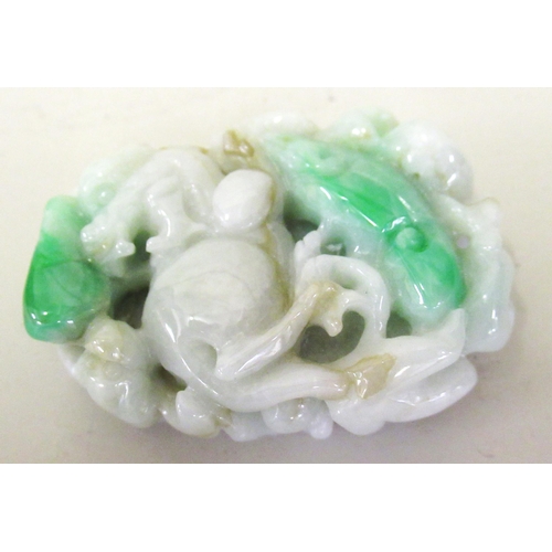 125 - Small 20th Century two colour green jade pendant, carved with an animal figure, 4.5cm x 3.5cm approx... 