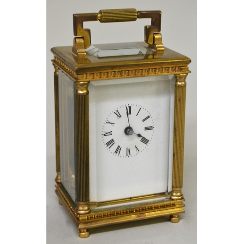Miniature gilt brass cased carriage clock, the enamel dial with Roman numerals, the case with reeded corner pilasters and single train movement, 8cm high excluding the loop handle