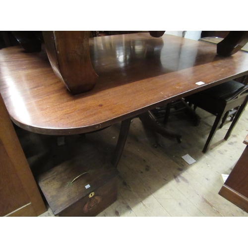 Large early 19th Century rectangular mahogany tilt top pedestal table, the two plank top, on baluster turned column with splay supports having original brass caps and casters, 72cms high x 110cms x 154cms