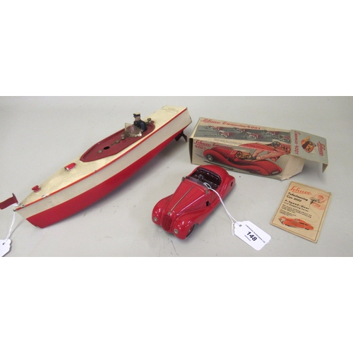 148 - Schuco clockwork toy car in original box, together with a mid 20th Century tin plate clockwork model... 