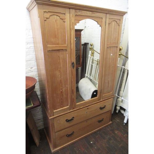 1490 - Victorian stripped pine wardrobe, the moulded cornice above a single mirrored door and two drawers w... 