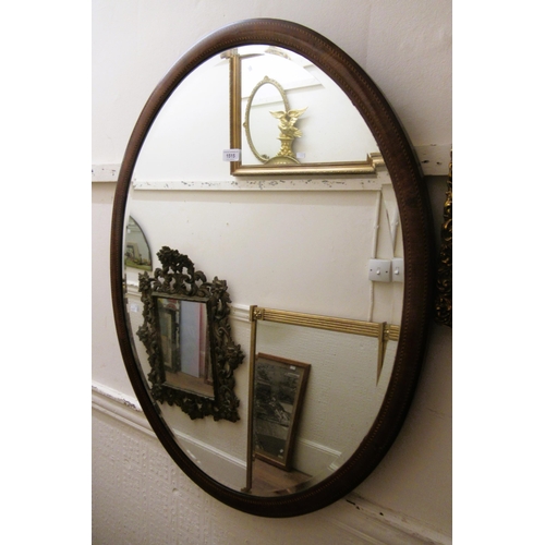 1515 - Large Edwardian oval mahogany chequer inlaid bevel edged hanging wall mirror, 95 x 74cm