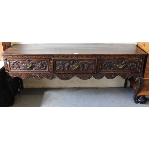 1529 - 18th Century oak low dresser base having three short drawers on cabriole supports, with later all-ov... 