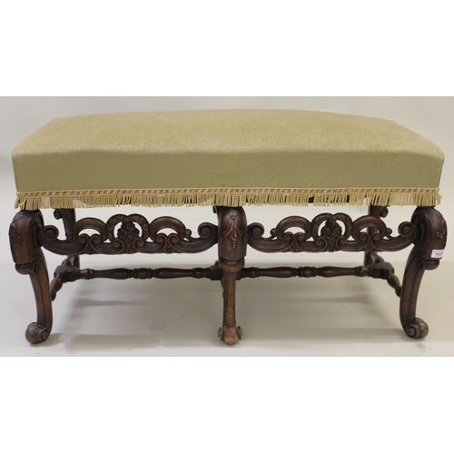 Late 19th / early 20th Century walnut rectangular stool in Carolean style, with overstuffed seat above six cabriole supports with pierced stretchers, 140cm wide