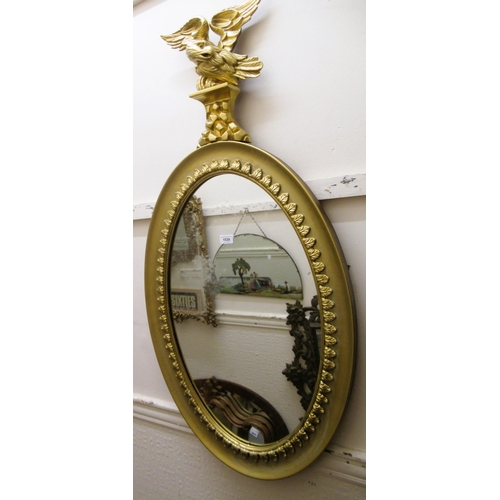 1539 - Oval gilt framed wall mirror with eagle surmount (with alterations), 115cm high