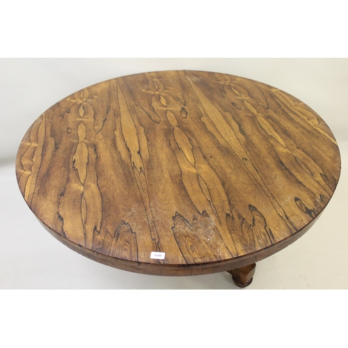 1549 - Victorian circular rosewood centre table on turned column and triform base, raised on low bun feet, ... 